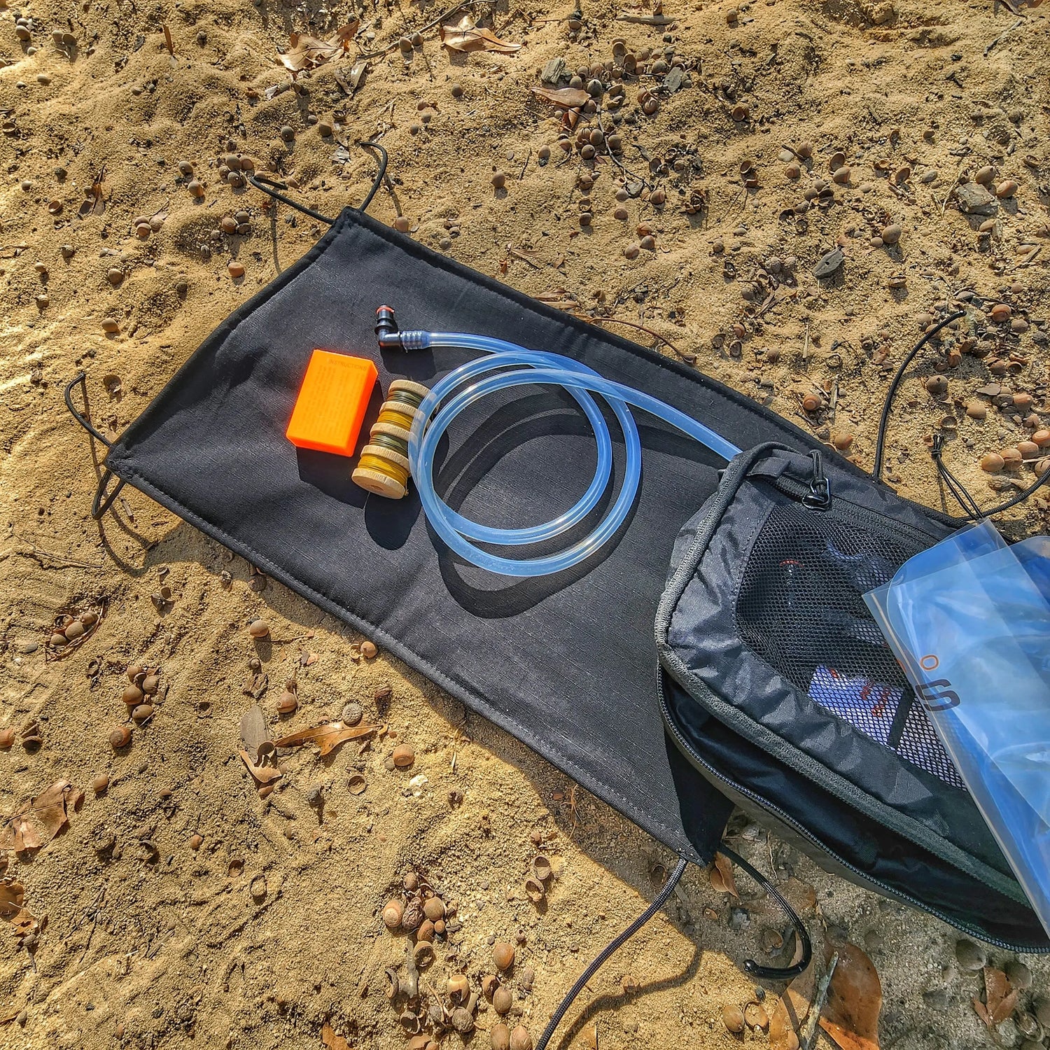 Woobie Hank: Insulated with USGI poncho-liner, serves as a large rag, knee pad, and adventure companion tool. Superesse Straps LLC