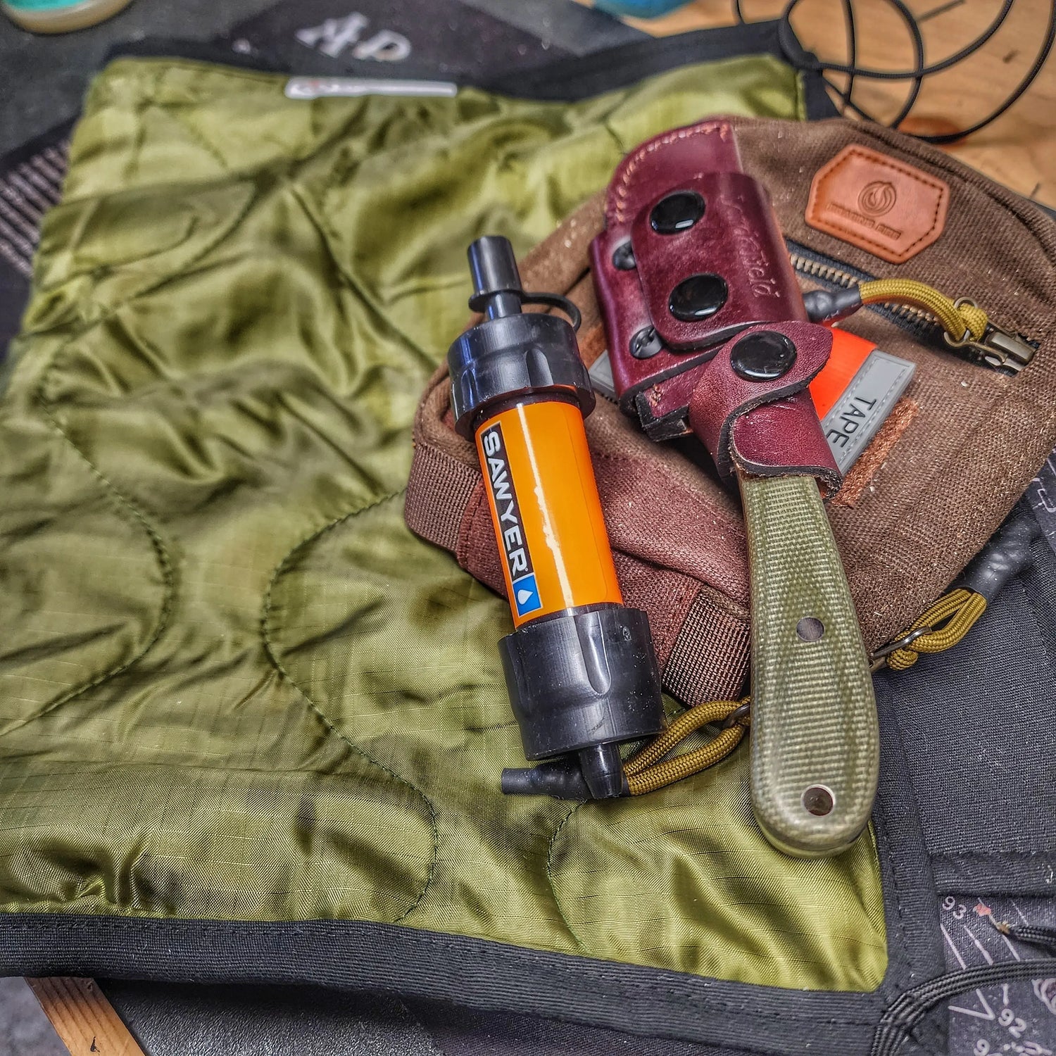 Woobie Hank: Insulated with USGI poncho-liner, serves as a large rag, knee pad, and adventure companion tool. Superesse Straps LLC